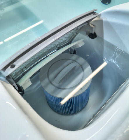 Hot tub skimmer area with filter cartridge in place handling mechanical filtration of the water